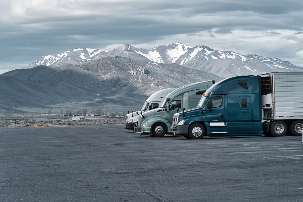 Blue and Gray trucks in front of mountains